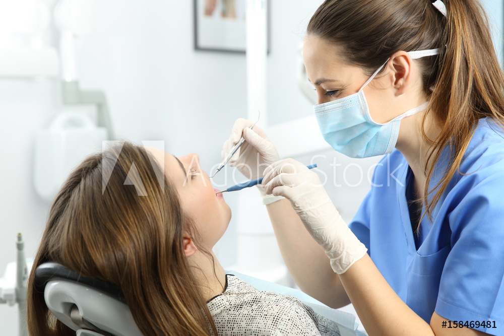 Smiling woman with clean, white teeth after a professional dental cleaning